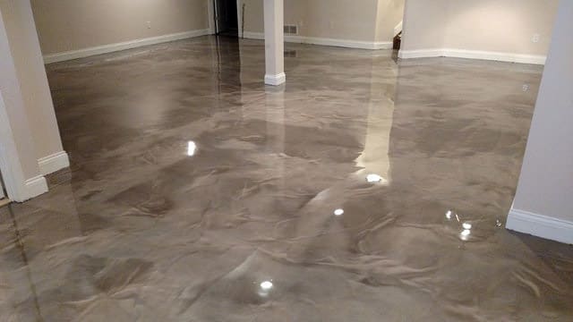 Polished concrete floor with marbled design in an empty room.
