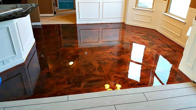 Glossy finished concrete floor with reflections in a modern kitchen.