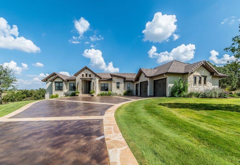 concrete driveway with decorative border and brown concrete staining
