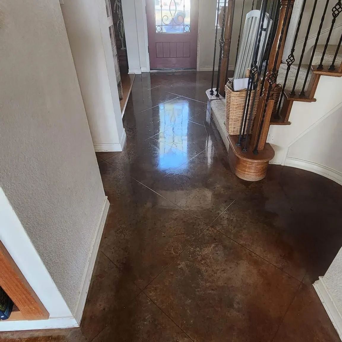 decorative concrete floors in a home entry that are etched, stained and polished